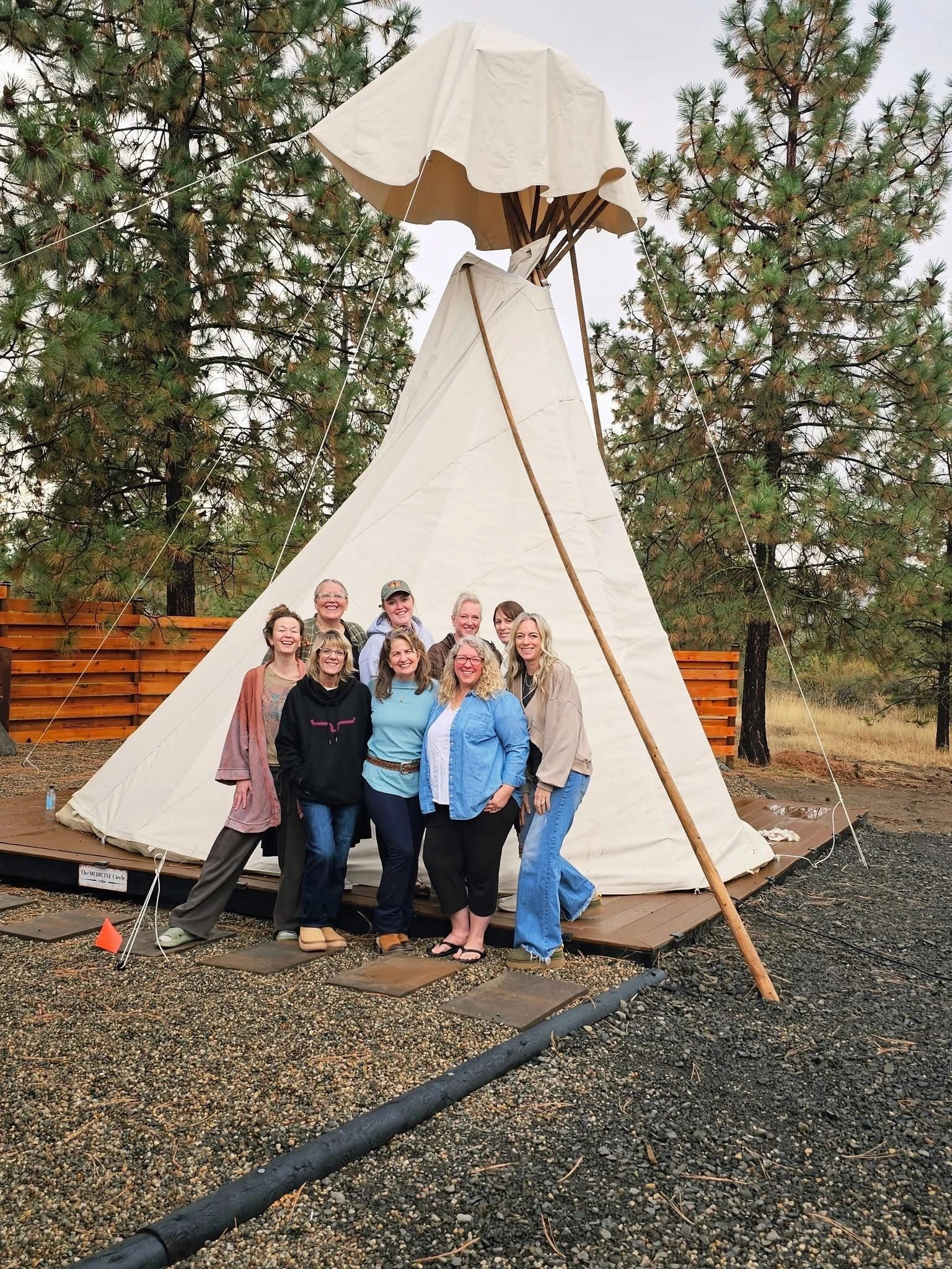 Retreat group at a tipi in the forest